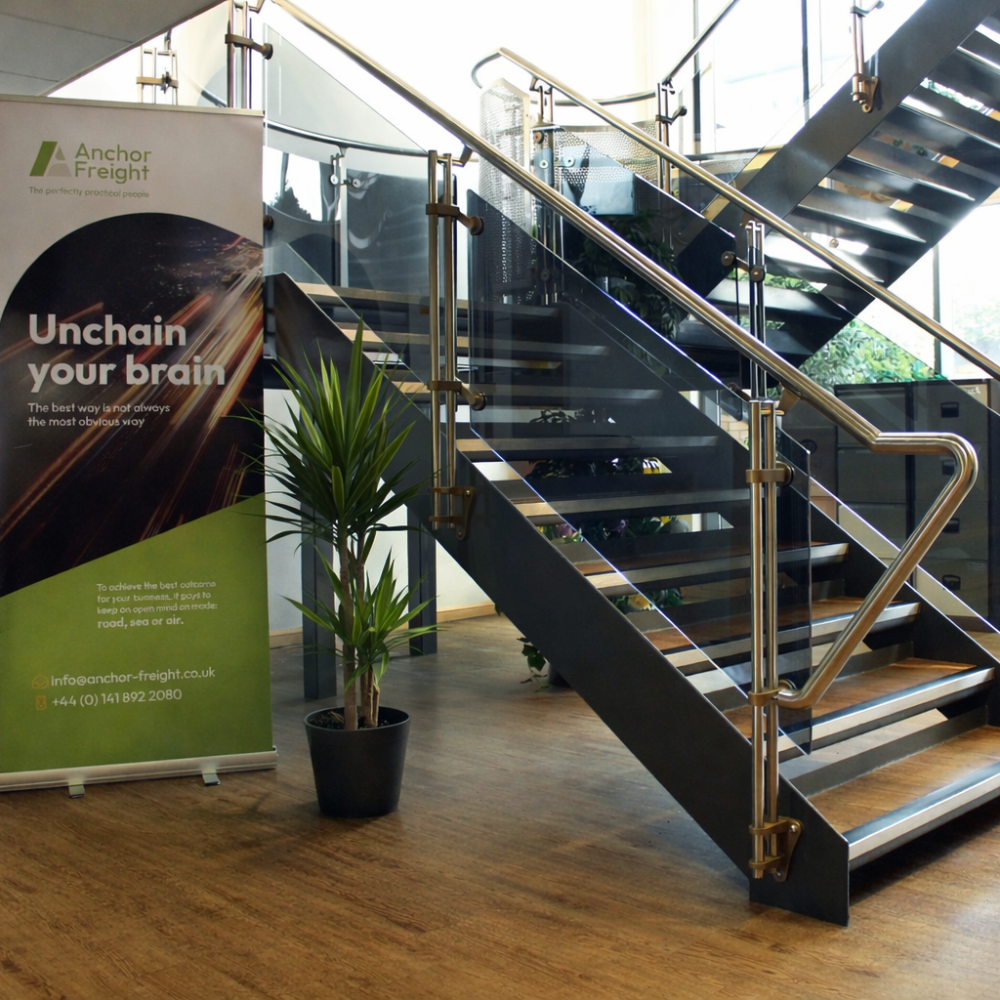 Modern office with branded banner and plant